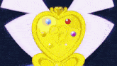 a close up of a necklace with a heart and a diamond on it
