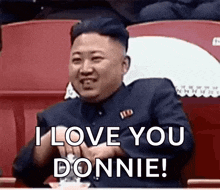 kim jong un is sitting in a stadium and saying `` i love you donnie ! ''