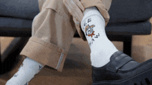 a person wearing a pair of socks with a cowboy on it