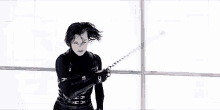 a woman is holding a whip in front of a man who is holding a sword