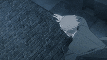 a man in a suit is laying on a brick sidewalk