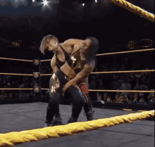 a woman is wrestling another woman in a ring .