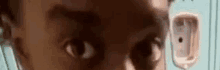 a close up of a person 's eyes in front of a urinal .