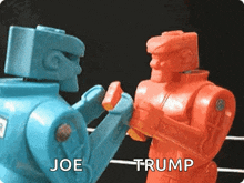 two toy robots are fighting each other and the words joe and trump are visible