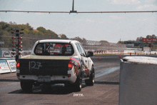 a white truck with the number 27 on the back of it