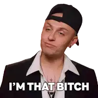 a man wearing a hat and a suit says " i 'm that bitch "