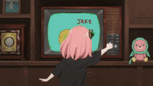a girl with pink hair stands in front of a television that says finn on it