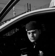 a man wearing a black hat with the number 13 on it