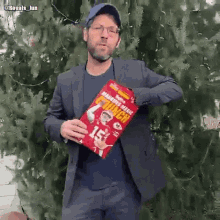 a man in a suit is holding a bag that says crunch