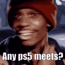 a man wearing a red hat is smiling and says any ps5 meets