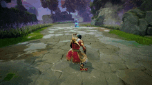 a man in a red and gold outfit is walking down a stone path