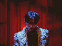 a man is wearing a jacket with pearls on it and the word chenleyah is on the bottom
