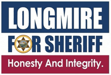 a sign that says longmire for sheriff honesty and integrity on it