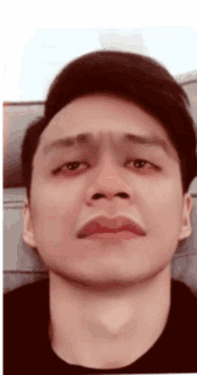 a man is making a funny face with his mouth open .