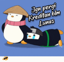 a penguin wearing a hat and scarf is standing next to another penguin who is laying down