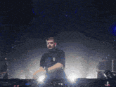 a man is singing into a microphone while playing a dj set