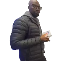 a man wearing glasses and a padded jacket is holding a bag of chips