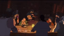 a group of people are sitting around a table in a dark room playing a game