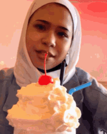 a woman with a cherry on top of her milkshake