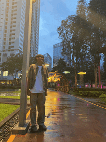 a man in a white shirt is standing next to a street light