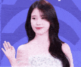 a woman in a white off the shoulder dress is giving a peace sign