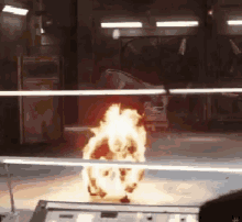 a person is watching a fire explosion through a window