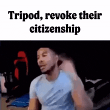 a man in a white shirt is standing in a dark room with the words tripod , revoke their citizenship above him .