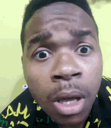 a close up of a man 's face with a shirt that says " am " on it