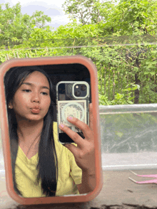 a girl is taking a picture of herself in the mirror