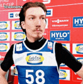 a man wearing a blue and white lavita number 58 jersey