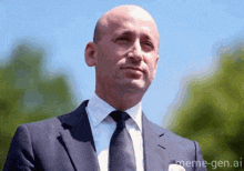 a bald man in a suit and tie with meme-gen.ai on the bottom right