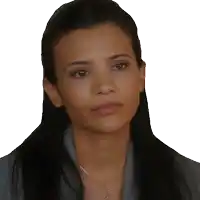 a woman wearing earrings and a necklace looks serious