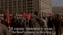 a crowd of people walking down a street with the words the heart 's uneasy in the chest in the corner
