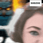a close up of a woman 's face with the word shizhi on the bottom right