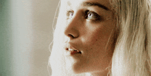 a close up of a woman 's face with a serious look on her face