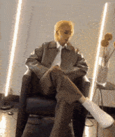 a person is sitting in a chair with their legs crossed and wearing white boots .