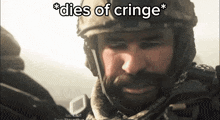 a man with a beard wearing a helmet with the words dies of cringe