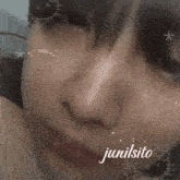 a close up of a person 's face with the name junilsito written below it