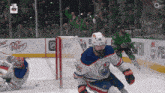 a hockey game is being played in front of a dr pepper ad