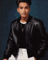 a pixelated image of a young man wearing a black jacket