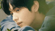 a close up of a person 's face with a blue shirt