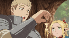 a man and a girl are standing next to each other and the man is holding something in his hand