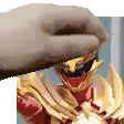 a close up of a person holding a sword over a cartoon character 's head .
