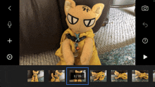 a stuffed animal with a yellow cape is shown in a video being edited