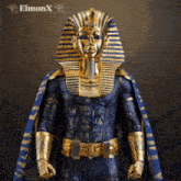 a statue of a pharaoh wearing a blue and gold cape