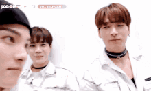 two young men are standing next to each other in front of a sign that says kcon