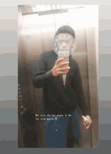 a man is taking a picture of himself with a clock on his face