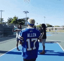 a man wearing a blue jersey with the name allen on it