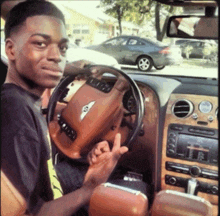 a young man sitting in a bentley car giving the middle finger