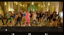 a group of people are dancing in a room with the numbers 03 05 on the screen